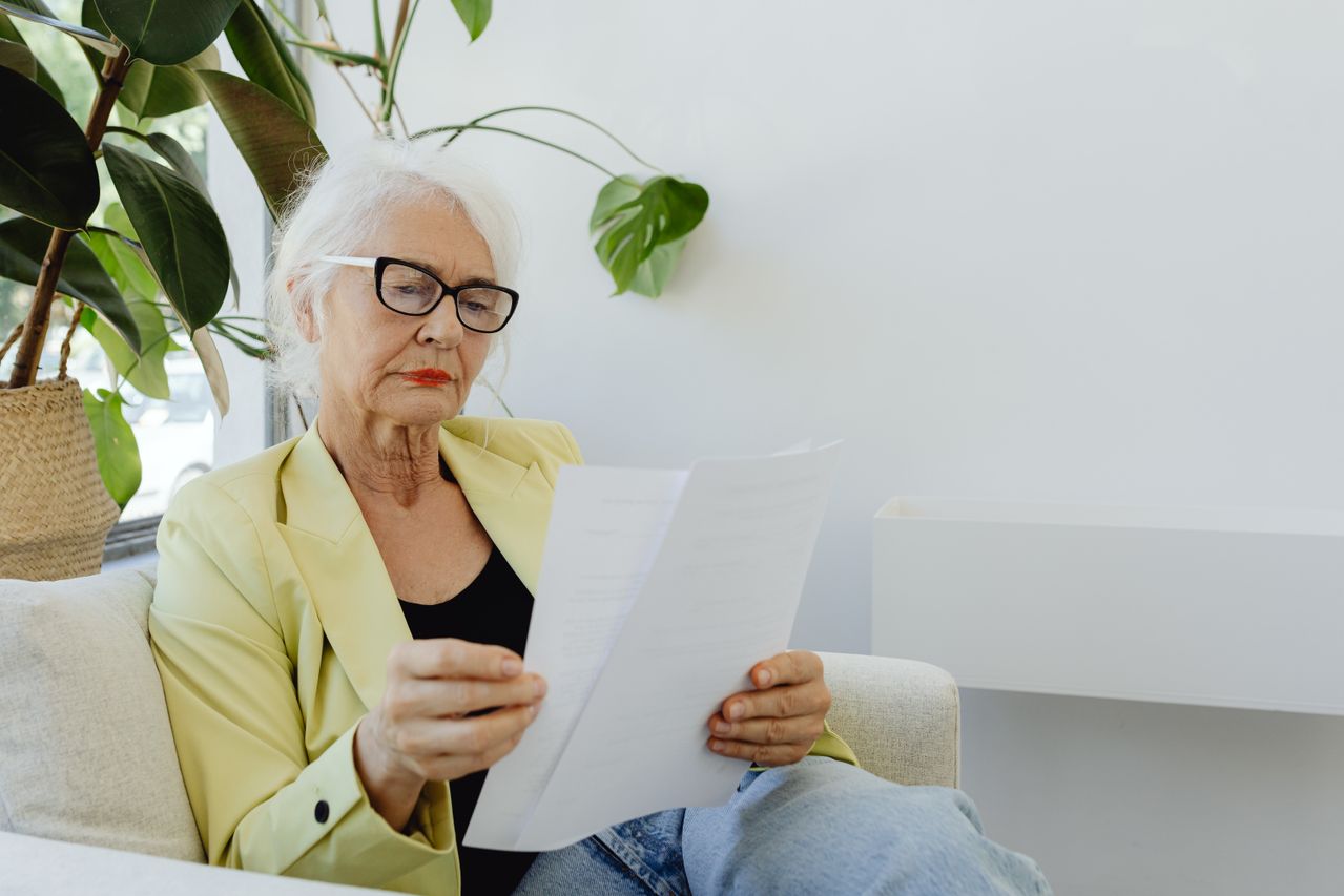 Woman reading her printed blood test results at home