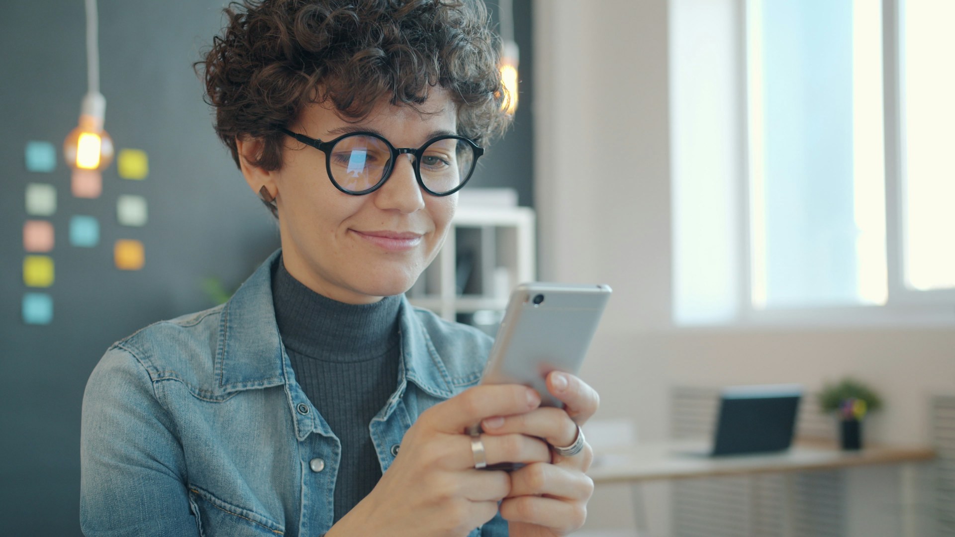 The managing, woman checking her markers on her phone